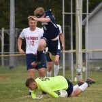 Devin Edds leaps over the Patriot keeper